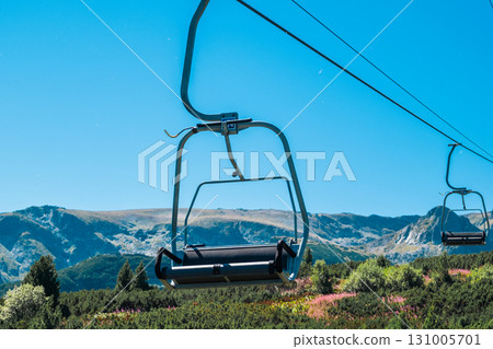 Chair Lift above the mountains and green forest of Bulgaria. Eco tourism. Tourist attraction. Seven Rila lakes. Cable car in the Rila Mountains 131005701