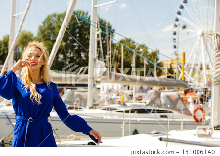Fashion model against ferris wheel Fashion model against ferris wheel 131006140