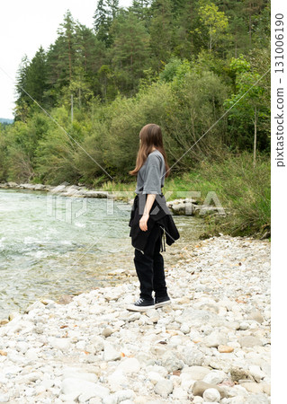 Teen Girl Walking Along the River in Nature 131006190