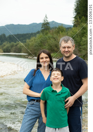 Happy family mom, dad and child walking in nature Happy family mom, dad and child walking in nature 131006191