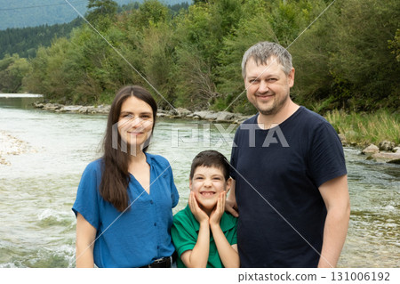 Happy Family with Mom Dad and Child Walking Together in Nature. 131006192
