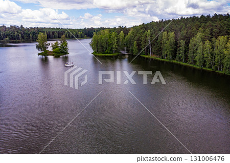 Aerial view yacht on lake in Tuchola Forests, Poland. Aerial view yacht on lake in Tuchola Forests, Poland. 131006476