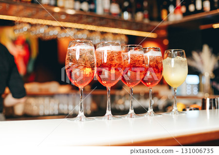 Aperol spritz being prepared on the bar in a cocktail bar. Aperol spritz being prepared on the bar in a cocktail bar. 131006735