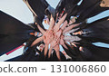 Group of students in graduation gowns link hands to celebrate their achievement in a circle 131006860
