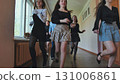 High school girls and teacher happily running in school hallway during break, cherishing their youth and friendship 131006861
