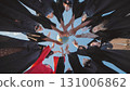 Group of graduates in academic gowns forming a circle, holding a globe, symbolizing global education and future opportunities 131006862
