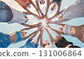 School friends coming together in a circle, representing their unity, teamwork, and strong bond 131006864