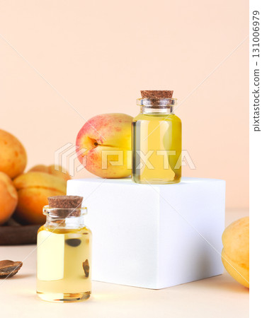 Bottles of apricot oil with ripe apricots on pastel background. Organic skincare and natural beauty treatment concept. 131006979