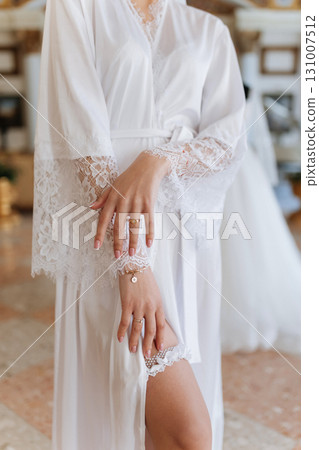 Bridal morning details with lace robe, jewelry and garter close up Bridal morning details with lace robe, jewelry and garter close up 131007512