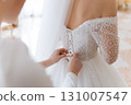 Bridal dress back lacing close up on wedding morning preparation moment 131007547