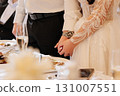 Bride and groom holding hands at wedding dinner, elegant and emotional close up moment 131007551