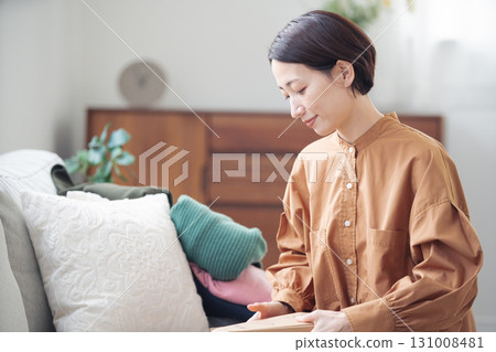 A Japanese woman in her 40s holding an item purchased online A Japanese woman in her 40s holding an item purchased online 131008481