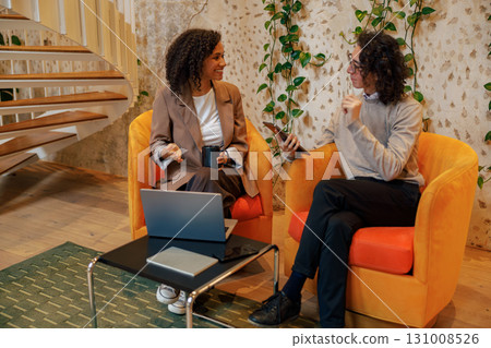 The modern business meeting takes place in a vibrant and creative workspace environment 131008526