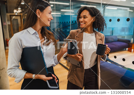 Colleagues collaborate positively in an office that fosters teamwork and innovation Colleagues collaborate positively in an office that fosters teamwork and innovation 131008554