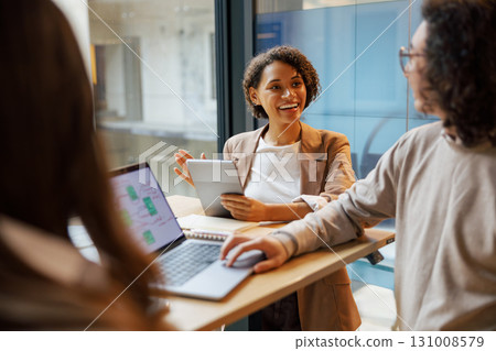 Participating in an Engaging, Productive Business Meeting Held in a Modern, Innovative Workspace Participating in an Engaging, Productive Business Meeting Held in a Modern, Innovative Workspace 131008579