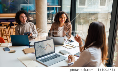 A collaborative business meeting is currently taking place within a modern workspace setting A collaborative business meeting is currently taking place within a modern workspace setting 131008713