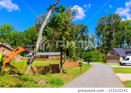 Tree removal process in residential area with heavy machinery on works day 131010141