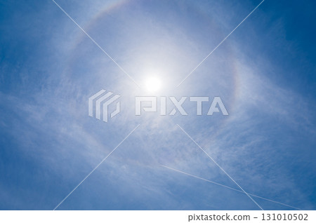 White clouds and sun halo phenomenon in the blue sky 131010502