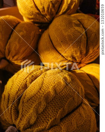 Yellow knitted pumpkins creating cozy autumn atmosphere Yellow knitted pumpkins creating cozy autumn atmosphere 131010659