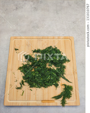 Freshly chopped dill resting on a bamboo cutting board copy space Freshly chopped dill resting on a bamboo cutting board copy space 131010767