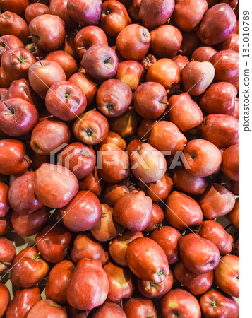 Red apples forming a colorful display at a market stall 131010789