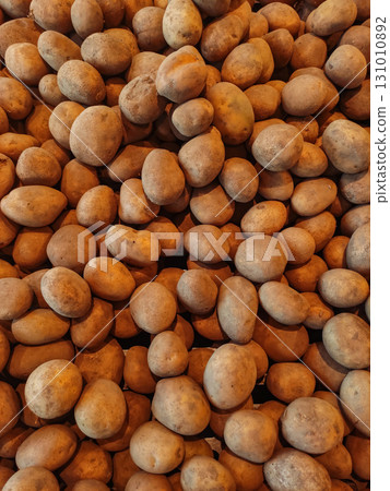 Fresh potatoes forming a textured background at local market 131010892