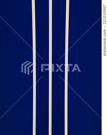 Three vertical beige stripes on dark blue background creating modern and minimalist pattern Three vertical beige stripes on dark blue background creating modern and minimalist pattern 131010987