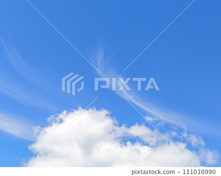 Wispy cirrus clouds painting the vibrant blue sky over slovakia Wispy cirrus clouds painting the vibrant blue sky over slovakia 131010990