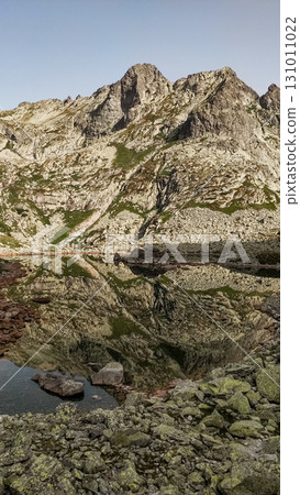 Rysy mountain reflecting in a glacial lake in the high tatras, slovakia 131011022