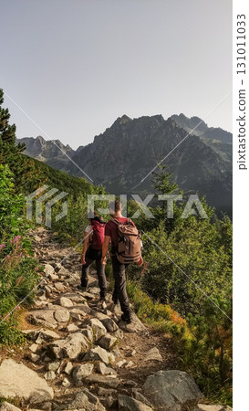 Hikers walking on rocky path in high tatras mountains 131011033