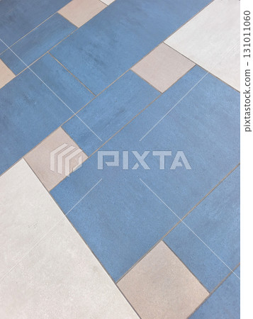 Geometric pattern of blue and white tiles creating visual interest on a floor 131011060