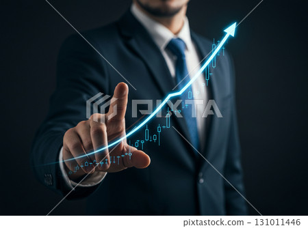 Businessman pointing at upward trend graph 131011446