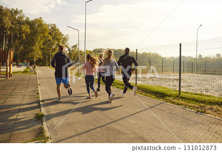 Team Of Athletes Running And Jogging In A City Park Team Of Athletes Running And Jogging In A City Park 131012873