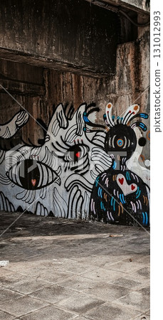 A vibrant and emotional graffiti mural on a concrete wall in the city. 131012993