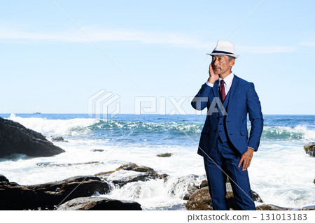 海邊一位穿著西裝的花花公子中年男子的畫像 131013183