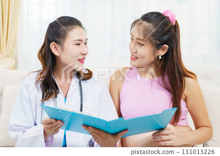 An Asian pregnant woman have an monthly health check with a doctor in hospital to check about her pregnancy. A health care and wellbeing in pregnant woman. 131013226