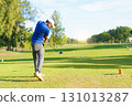 Asian male amateur golfer is enjoy playing golf at golf course in morning, he is showing his beautiful swing during tee off. Man playing golf. 131013287
