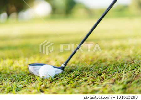 Asian male amateur golfer is enjoy playing golf at golf course in morning, he is showing his beautiful swing during tee off. Man playing golf. 131013288