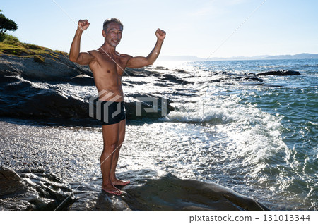 Portrait of a senior man with a well-trained body at the seaside Portrait of a senior man with a well-trained body at the seaside 131013344
