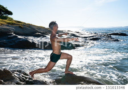Portrait of a senior man with a well-trained body at the seaside Portrait of a senior man with a well-trained body at the seaside 131013346
