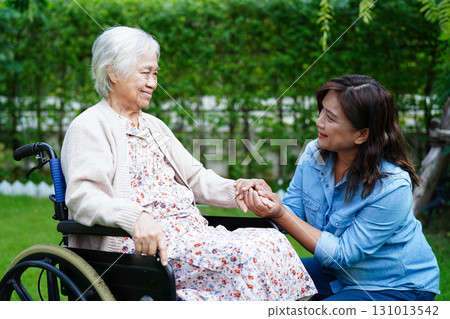 Caregiver help Asian elderly woman disability patient sitting on wheelchair in park, medical. Caregiver help Asian elderly woman disability patient sitting on wheelchair in park, medical. 131013542