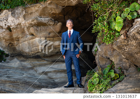 A man in a suit standing in a cave 131013637