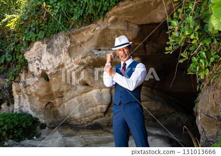 A man in a suit standing in a cave A man in a suit standing in a cave 131013666