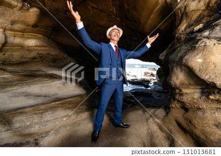 A man in a suit standing in a cave A man in a suit standing in a cave 131013681