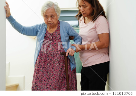 Caregiver help Asian elderly woman disability patient sitting on wheelchair in hospital. 131013705