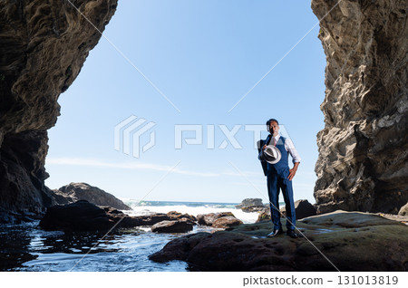 A businessman in a suit having trouble getting a cell phone signal in a cave A businessman in a suit having trouble getting a cell phone signal in a cave 131013819