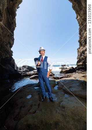 Portrait of a dandy middle-aged man in a suit at the sea 131013908