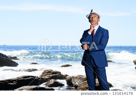 Portrait of a dandy middle-aged man in a suit at the sea 131014179