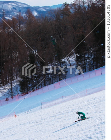 Skiers skiing down the Kamoshika course at the foot of the mountain at Hakuba Iwatake Snowfield 131014505