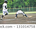 First baseman catches a low short ball and the batter runs to the base. 131014758